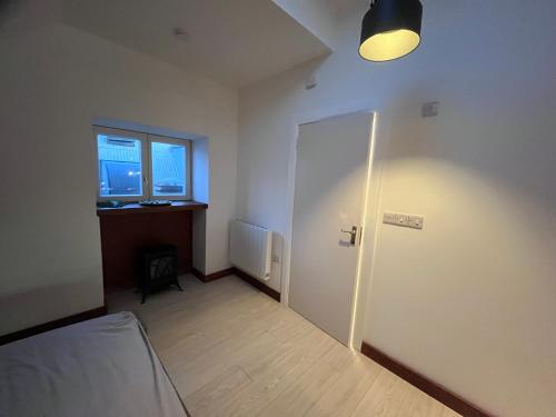 a room with a bed and a door and a window at Top Deck in Killorglin