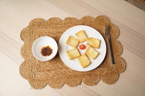 a plate of tofu and a bowl of sauce on a table at Pure in Mexico City
