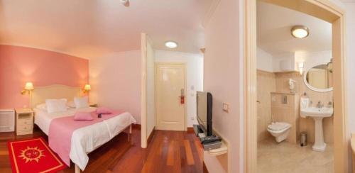 a bedroom with a large bed and a bathroom at Apartments and Room Luxury dream in Brela