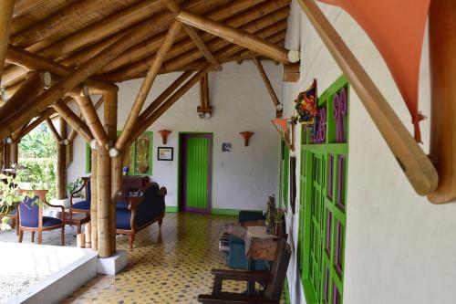 a living room with wooden ceilings and a green door at Hotel La Coqueta in Montenegro