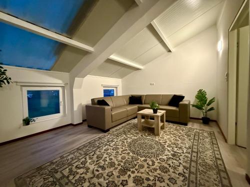 a living room with a couch and a table at Holiday Home Vijfhuizen in Vijfhuizen