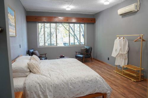 a bedroom with a large bed and a window at Pure in Mexico City