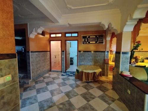 a large bathroom with a checkered floor and a room at Saidia Plage in Saidia 