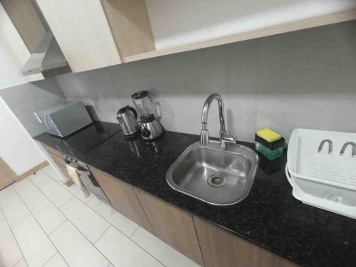 a kitchen with a sink and a counter top at Lovely View Studio Building Heated Pool Gym Turco WIFI in Quito