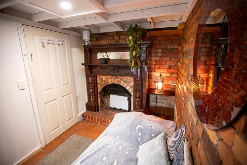 a living room with a brick fireplace and a couch at Fitzroy- Private rooms 2-4 guest #GuestHouse #AusGP #DirectTram #F1 in Melbourne