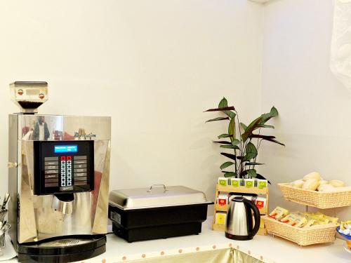 a kitchen counter with a coffee maker and other items at Hotel Firenze 2000 in Florence