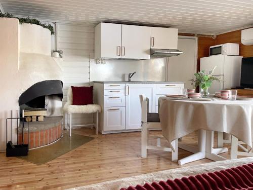 a kitchen with a table and a kitchen with a fireplace at Houses by The Sea in Salpar