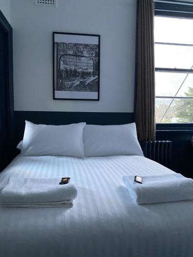 a bedroom with a bed with two towels on it at Royal Hotel Oberon in Oberon