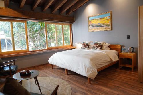 a bedroom with a bed in a room with windows at Pure in Mexico City