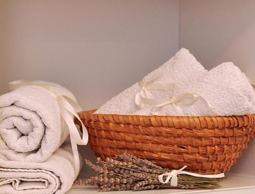 a basket of towels on a shelf in a bathroom at Apartment The Charm in Split