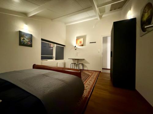 a bedroom with a bed and a table in it at Holiday Home Vijfhuizen in Vijfhuizen
