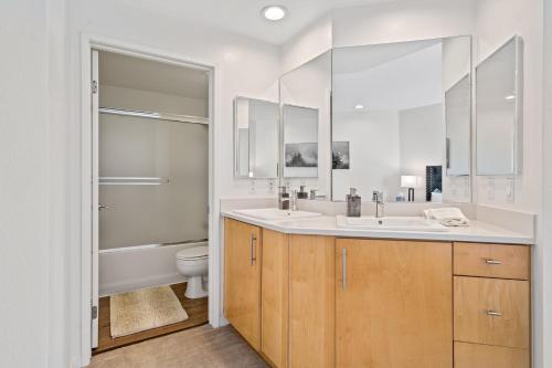 a bathroom with two sinks and a toilet at Venice Marina Water Front Luxury Condo in Los Angeles