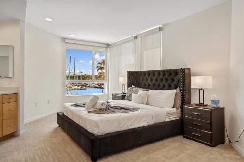 a bedroom with a large bed with a large window at Venice Marina Water Front Luxury Condo in Los Angeles