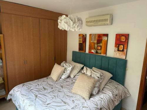 Un dormitorio con una cama con cabecero azul. en Real Torrequebrada, en Benalmádena