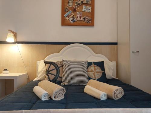 a bed with pillows on top of it with at Casa da Isabel - Centro da Nazaré in Nazaré