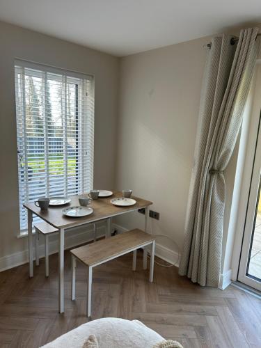 a dining room with a table and a window at Luxury Sunrise Guest House County Down in Killyleagh