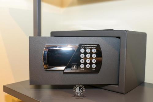 a microwave with a remote control sitting on a table at Palazzo Giudecca in Reggio Calabria