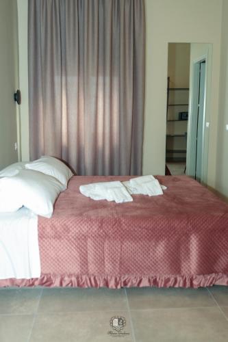 a bedroom with a bed with two towels on it at Palazzo Giudecca in Reggio Calabria