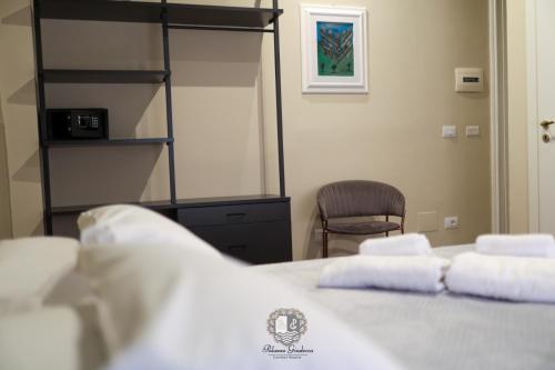 a bedroom with a bed with towels on it at Palazzo Giudecca in Reggio Calabria