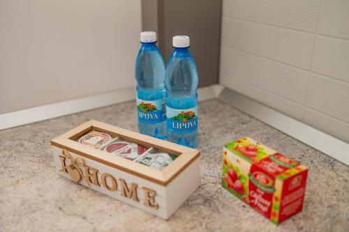 two bottles of water and a box on a counter at Urban Escape Arad in Arad