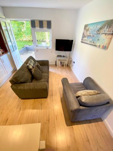 a living room with a couch and a tv at Little Wight House - Yarmouth in Freshwater