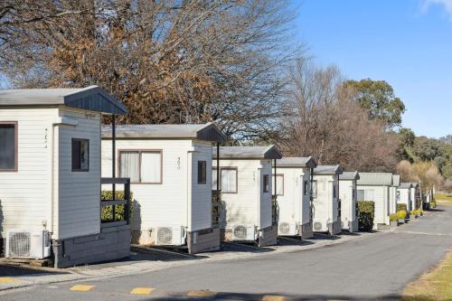 a row of white mobile homes on a street at Southside Village in Canberra