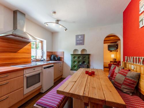 a kitchen with a wooden table in the middle of it at Haus Weissbach in Griessen