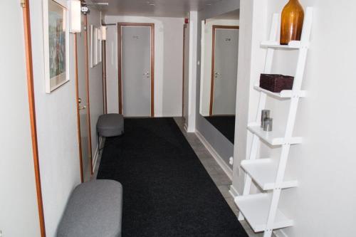 a hallway with white shelves in a room at Sveahuset Bed & Breakfast in Sala