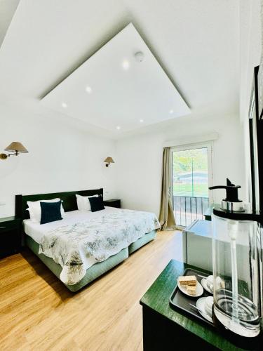 a bedroom with a bed and a large window at VALE MAR Guest in Ribeira Brava