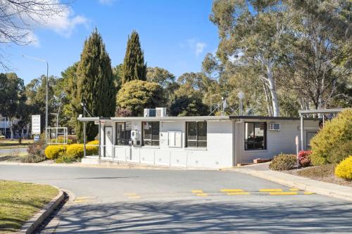 a small white house on the side of a road at Southside Village in Canberra