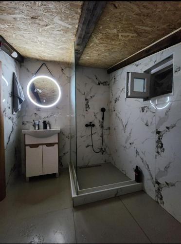 a bathroom with a shower and a sink at Luxurious attic apartment with a breathtaking view in Vranjina