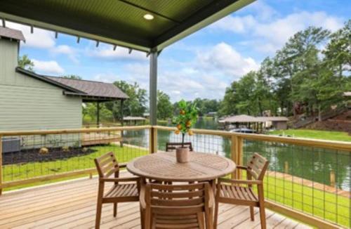 a patio with a table and chairs on a deck at Villas at Bay Ridge Unit 7 in Jacksons Gap
