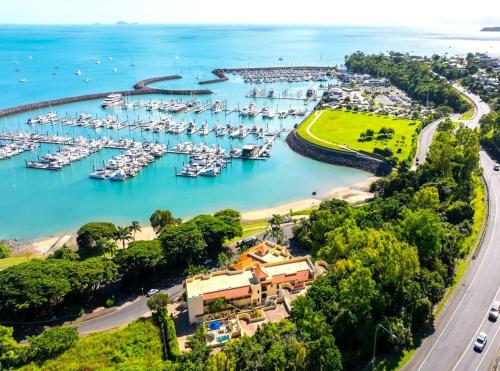 an aerial view of a marina with boats in the water at Shingley Beach Resort - Whitsundays in Airlie Beach