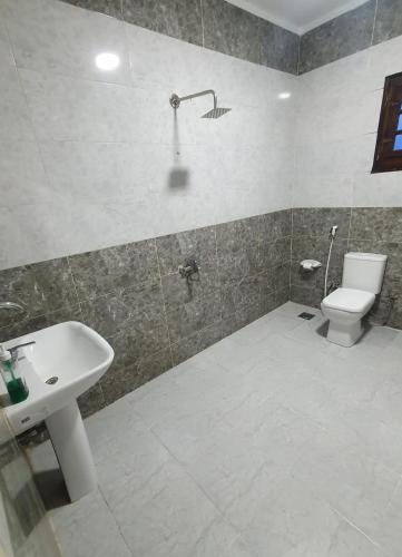 a bathroom with a sink and a toilet at Zein Pyramids View - Guest House in Cairo
