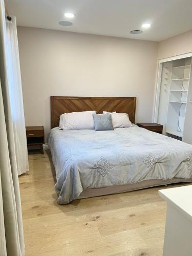 a bedroom with a large bed with two pillows at Luxury Home LA Big Bear & LV 5 Mins to Mall in Victorville