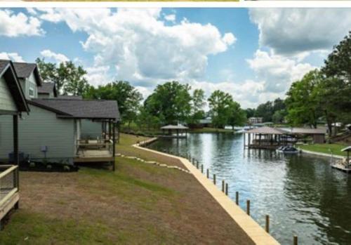 a river with a house and a boat on it at Villas at Bay Ridge Unit 10 in Jacksons Gap