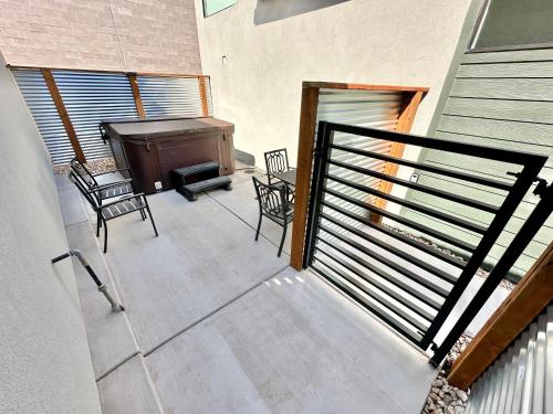 a patio with chairs and a piano on a balcony at Zion Oasis Rentals in Hurricane