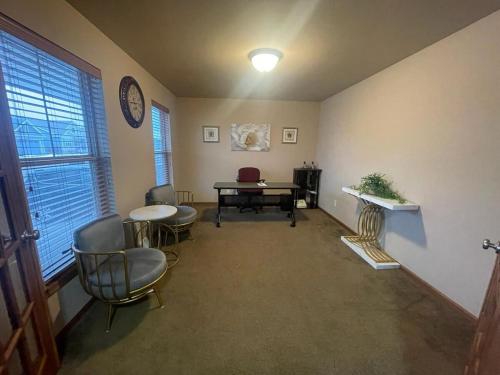a room with a table and chairs and a desk at Unique World Homes in Madison