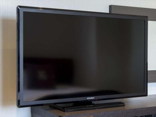 a flat screen tv sitting on top of a table at GR Hotel Suidocho in Kumamoto