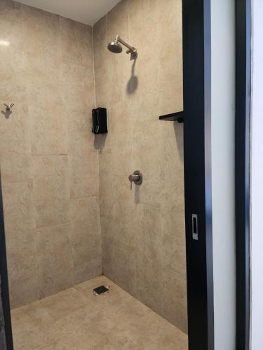 a bathroom with a shower with a shower head at POR Santitham in Chiang Mai