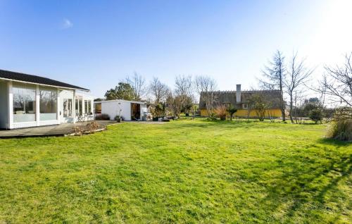 a yard with a house and a house at Cozy Home In Svendborg With Wifi in Svendborg