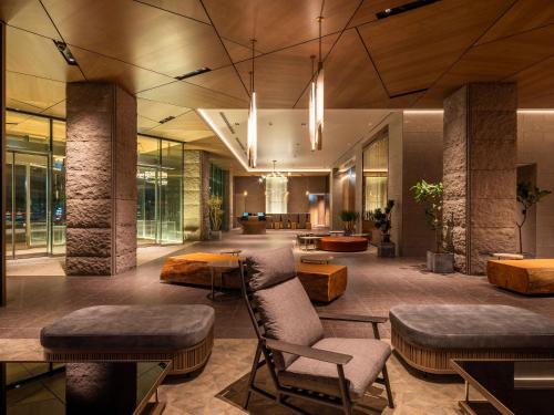 a lobby with chairs and tables in a building at SAPPORO HOTEL by GRANBELL in Sapporo