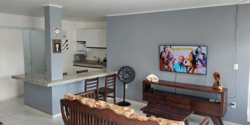 a living room with a flat screen tv on a wall at Maravilha do Patacho in Pôrto de Pedras
