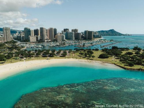 an aerial view of a beach and a city at First Cabin International Hawaii in Honolulu