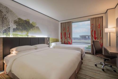 大園区にあるHyatt Regency Taoyuan International Airportのベッドが2つと窓があるホテルの部屋