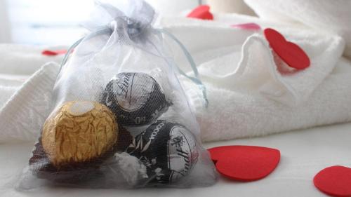 a teddy bear in a plastic bag on a bed at Le Chalet Suisse in Mont-Blanc