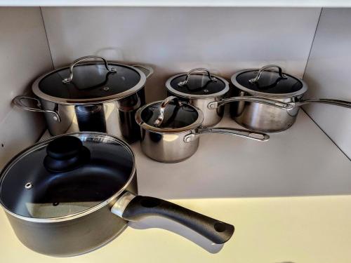 a group of pots and pans on a kitchen counter at Le Chalet Suisse in Mont-Blanc