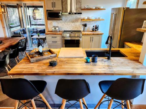 a kitchen with a large wooden table with four chairs at Le Chalet Suisse in Mont-Blanc