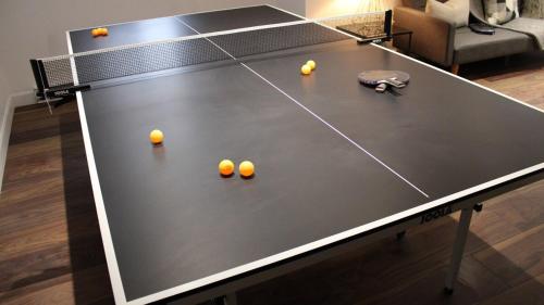 a black ping pong table with balls on it at Le Chalet Suisse in Mont-Blanc