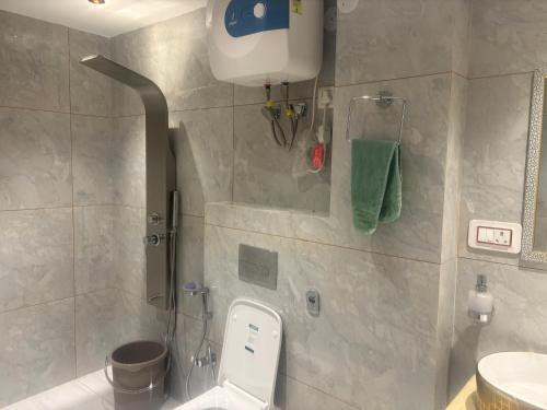 a bathroom with a shower with a toilet and a sink at Anayah B and B in Shimla